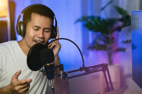 Premium Photo Man Singing With Headphone Recording New Song With