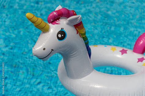 Inflatable unicorn floating in swimming pool. Unicorn inflatable pool float. Stock Photo | Adobe ...