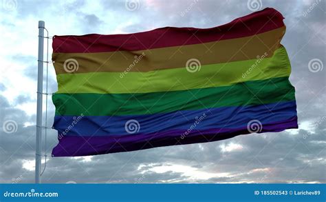 The Rainbow Flag LGBT Pride Gay Pride Flag Waving In The Wind Against