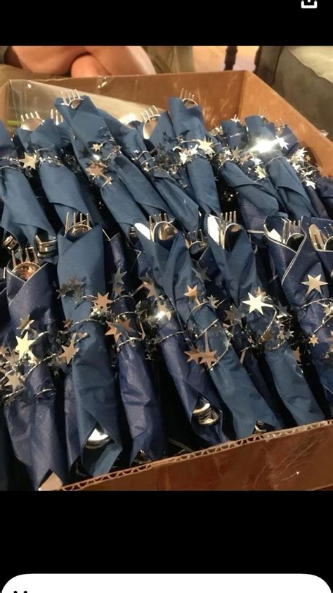 A Box Full Of Blue Napkins With Gold Stars On Them