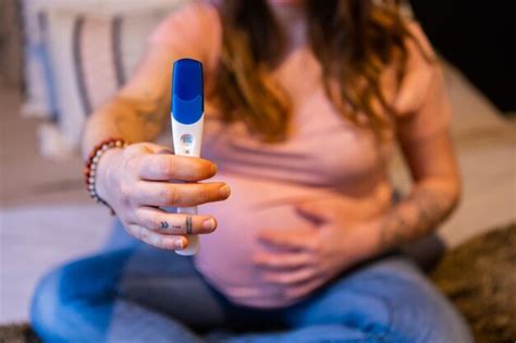 Premium Photo Midsection Of Pregnant Woman Holding Pregnancy Test Kit