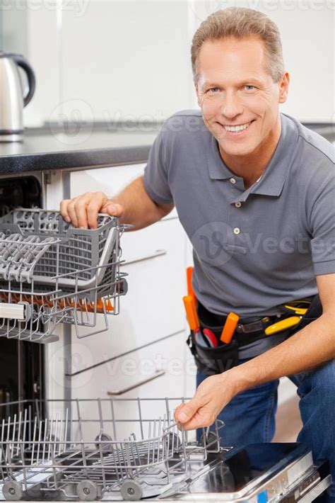 He can fix anything. Cheerful grey hair handyman smiling at camera 13575570 Stock Photo at Vecteezy