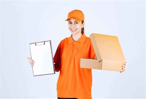 Free Photo Female Courier In Orange Uniform Holding An Open Cardboard