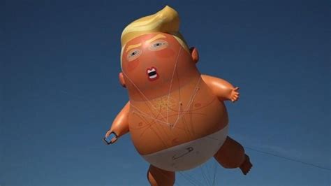 Baby Trump balloon greets President Donald Trump at US-Mexico border