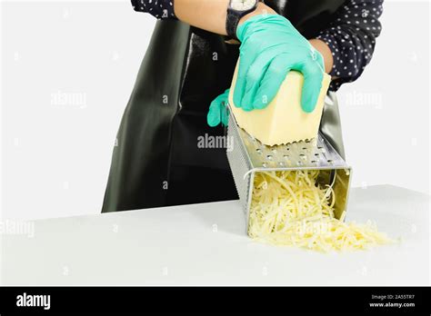 Woman Grating Cheese On Kitchen Table Isolated In Clipping Path Stock