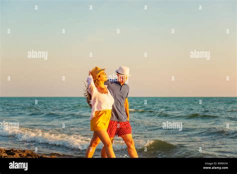 Happy Romantic Middle Aged Couple Enjoying Beautiful Sunset Walk On The