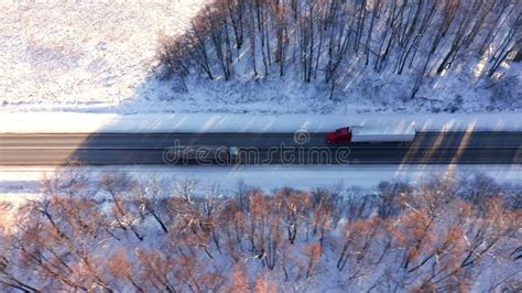 View From Above Of The Track On Which Long Lorries With Trailers Are