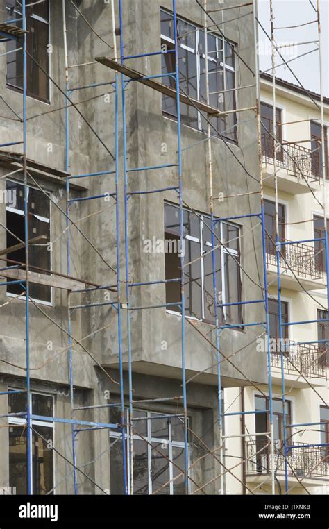 Naked Concrete Wall Without Facings In The Building With New Windows