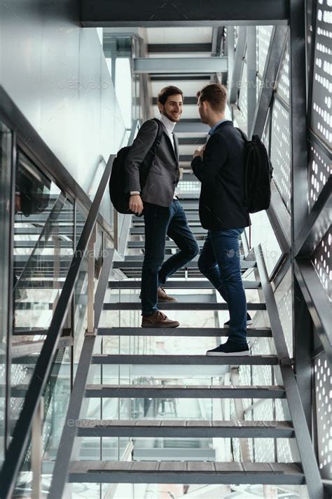 Two Men Going Up Down Stairs While Chatting Stairs Walking Up