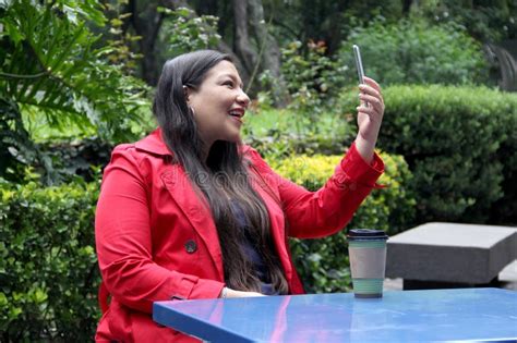 Year Old Divorced Single Latina Woman Uses Her Cell Phone To Make Video Calls Send Messages