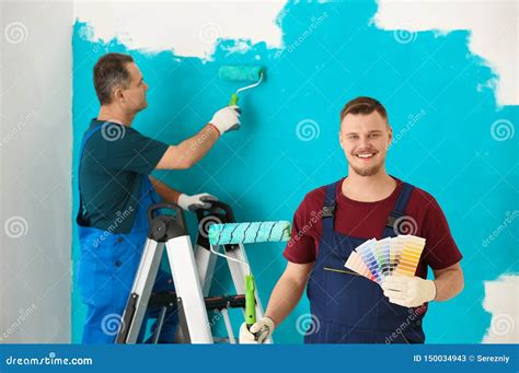 Male Painter In Uniform With Color Palette Samples And Roller Brush