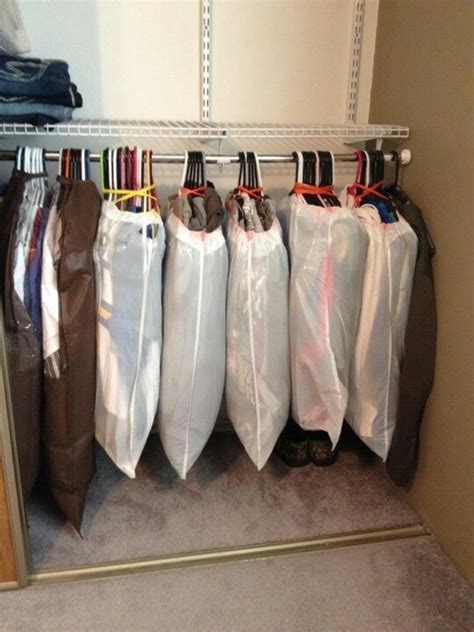 There Are Many Bags Hanging On The Rack In This Closet And One Bag Is