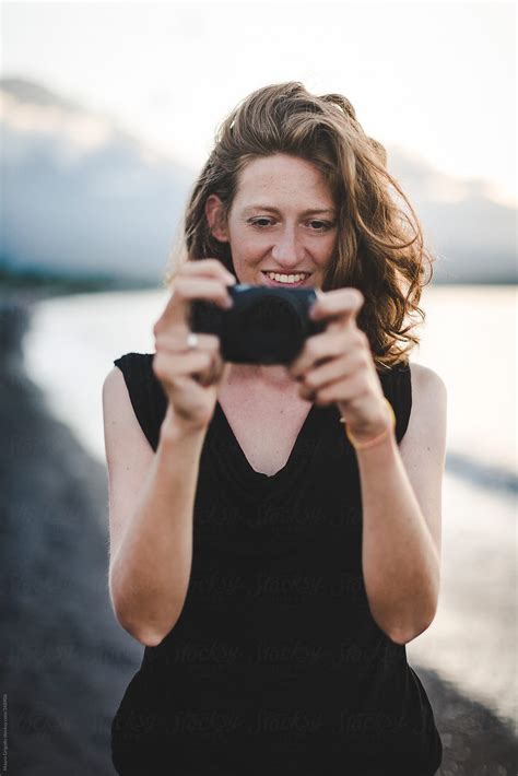 Woman Taking Pictures On The Beach By Stocksy Contributor Mauro