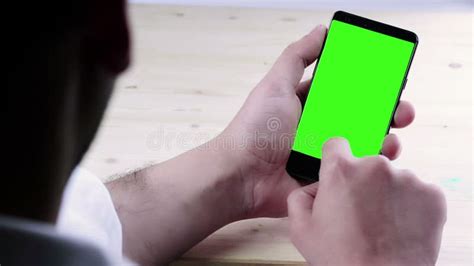 Man Hand Using A Smart Phone With Chroma Key On White Background Behind