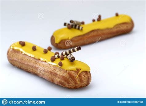 Eclair With Custard And Lemon Glaze On A White Background Confectionery For The Sweet Tooth