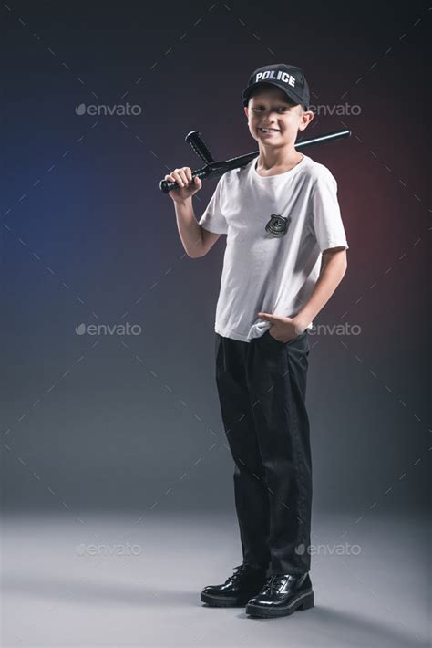 smiling boy in white tshirt and cap police officer uniform with ...