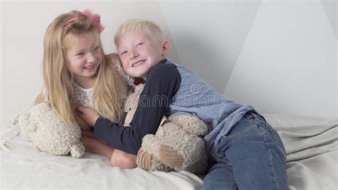 A Cute Brother And Sister Cuddle At Home Stock Video Video Of People