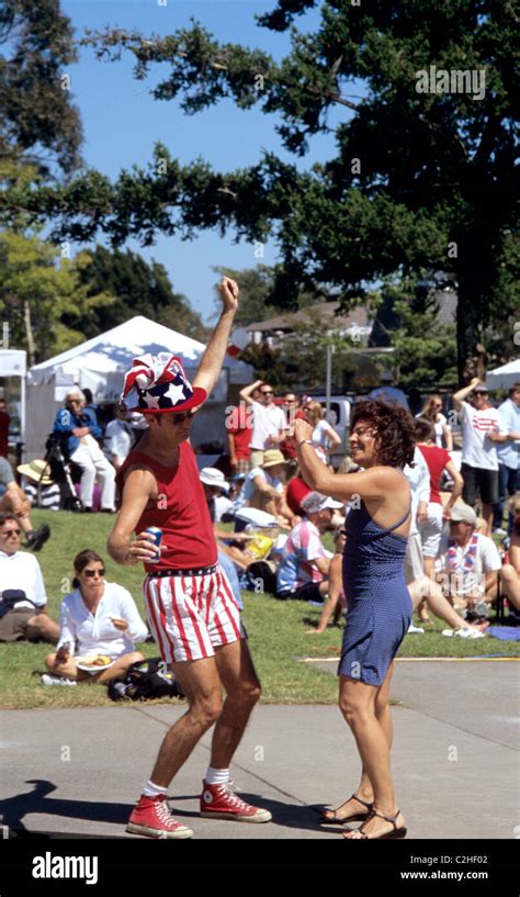 Man Dressed As Uncle Sam And Woman Dance At Local Community Park 4th Of