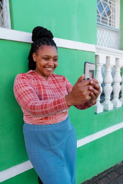 Free Photo Side View Woman Using Smartphone Outdoors