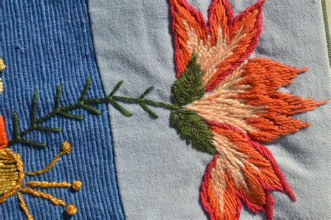 A Close Up Of A Piece Of Cloth With Embroidered Designs On It And A