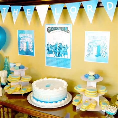 A Table Topped With Cakes And Desserts Covered In Blue And Yellow Icing