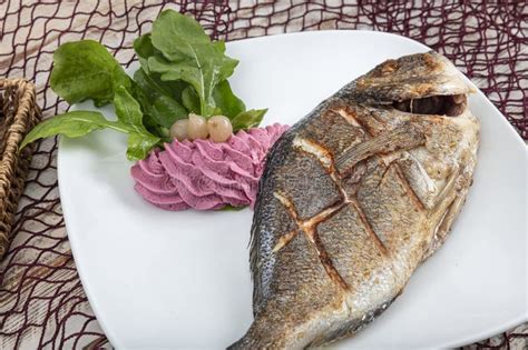 Grilled Gilthead Sea Bream On Plate With Lemon Salad And Grilled