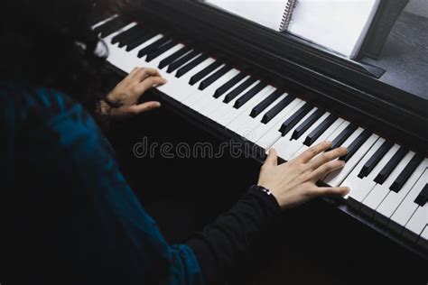 Close Up Of Womanand X27s Hands Playing Piano By Reading Sheet Music