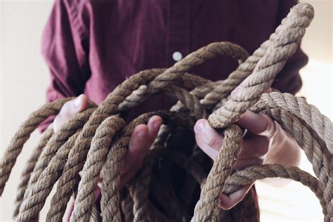 Close Up Photography Of Man Holding A Rope · Free Stock Photo