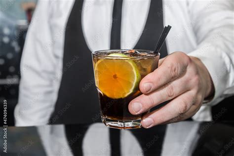 The Hand Of A Professional Bartender Serves An Alcoholic Beverage