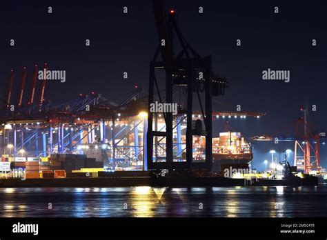 Container Ships Being Loaded At Night At The Container Terminal