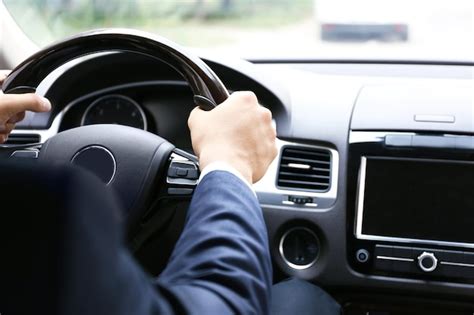 Premium Photo | Male hands on steering wheel closeup