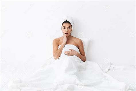 Shocked Emotional Amazing Woman With Towel On Head Lies In Bed Under