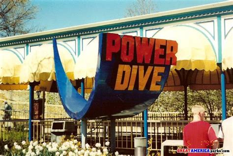 People Are Standing In Front Of A Large Sign That Says Power Dive On