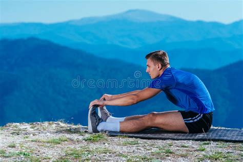 Athlete Long Distance Runner Stretching His Legs In Naturegetting