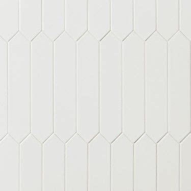 A White Tile Wall With Hexagonal Lines On The Top And Bottom As Well