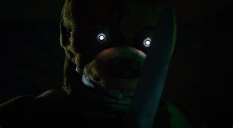 a creepy clown with glowing eyes holding a knife