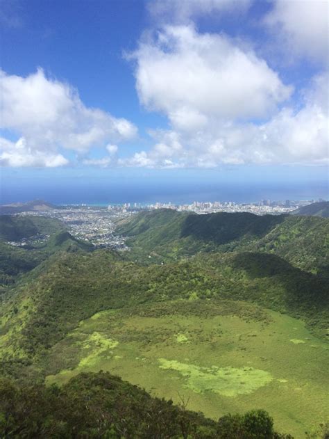 An Aerial View Of Some Mountains And The Ocean In The Distance With