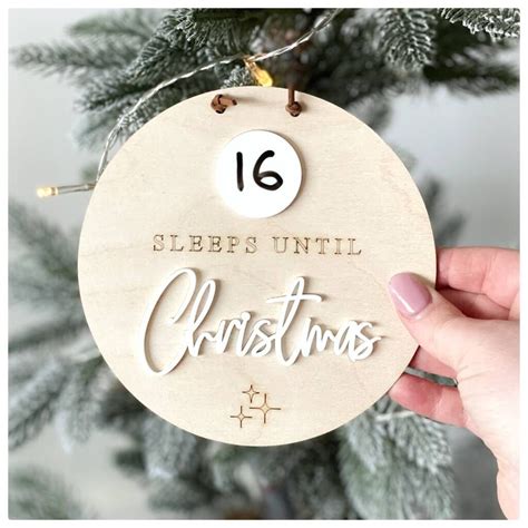 Someone Holding Up A Wooden Ornament With The Words Sleep Until