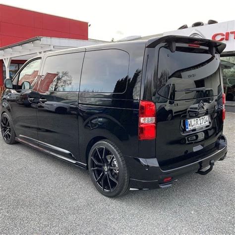 Black Van Parked In Front Of A Building