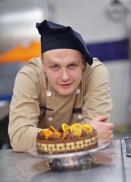 Premium Photo Closeup Of A Concentrated Male Pastry Chef Decorating Dessert Cake Food In The