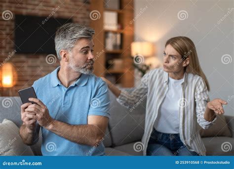 Sad Angry Middle Aged Caucasian Woman Yelling At Husband Gesticulates