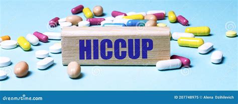 A Wooden Block With The Word Hiccup Stands On A Blue Background Among