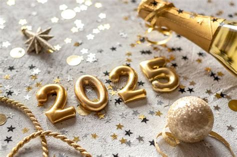 Golden New Year Numbers With Confetti And Champagne Bottle Stock