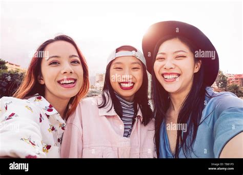 Portrait Of Laughing Young Woman Taking Selfie With Smartphone Hi Res