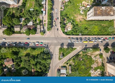 Top Down Aerial View Of Busy Street Intersection With Moving Cars