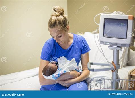 Mother Holding Her Newborn Premature Baby In The Hospital Stock Photo