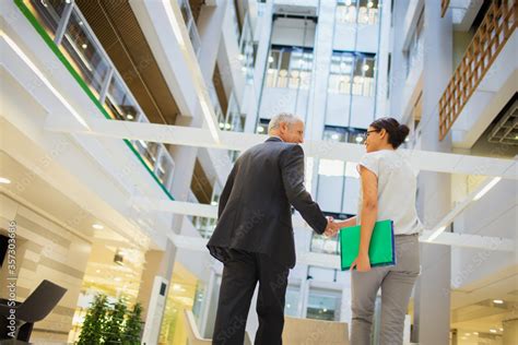 Business people shaking hands in office building Stock Photo | Adobe Stock