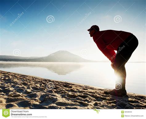 Man Exercising On Beach Silhouette Of Active Man Exercising And