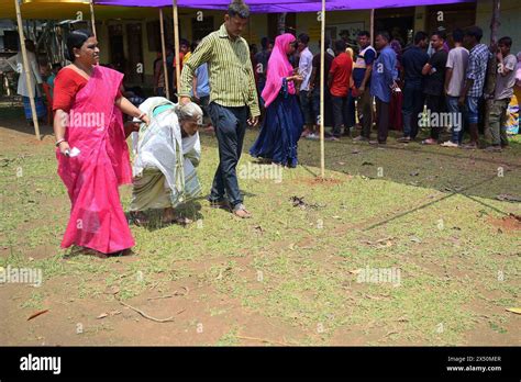 Volunteers Assist An Elderly Lady After She Casts Her Vote In The First