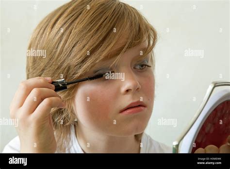 young boy putting makeup on pretending to be a girl Stock Photo - Alamy